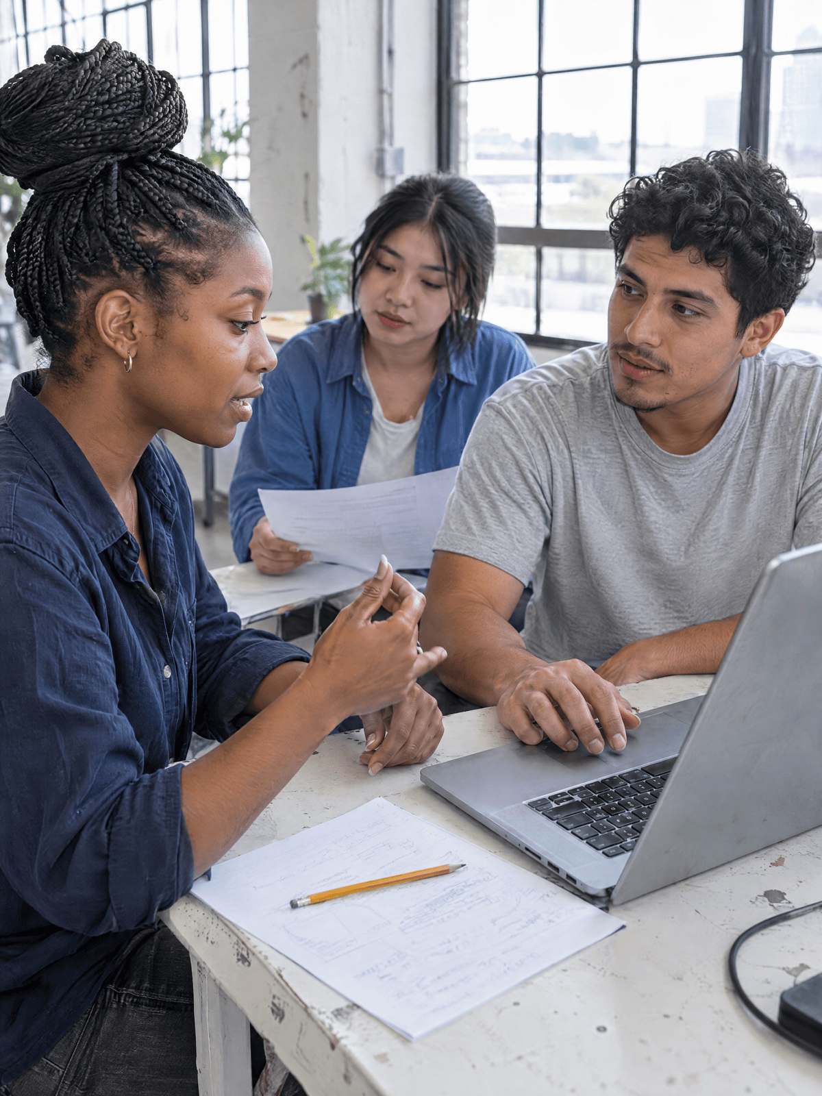 AI-generated fictional scene: three young adults testing a legal document workflow together in a learning studio.